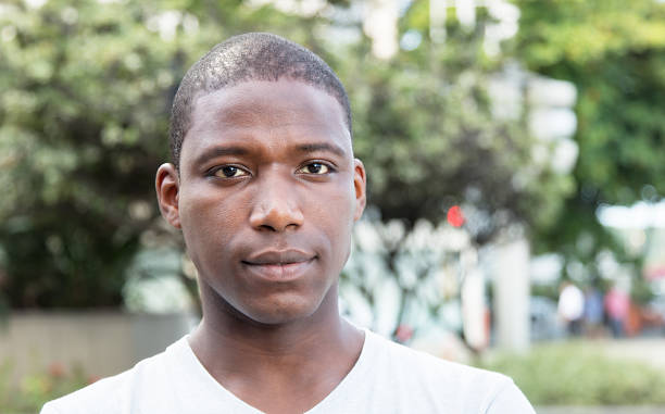 African american guy looking at camera outdoor in the city